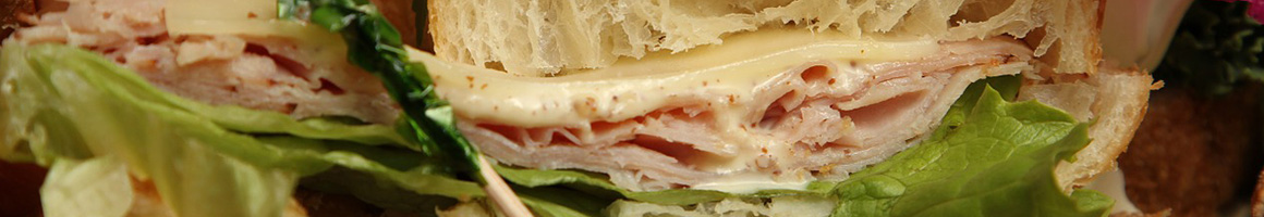 Eating Sandwich at Milio's Sandwiches restaurant in Cedar Rapids, IA.